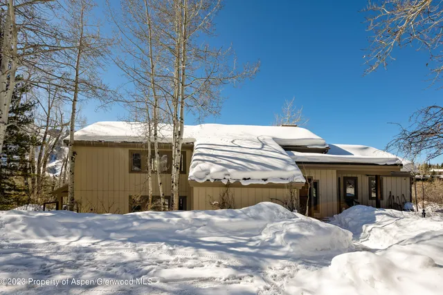 a view of a house with a snow in the yard