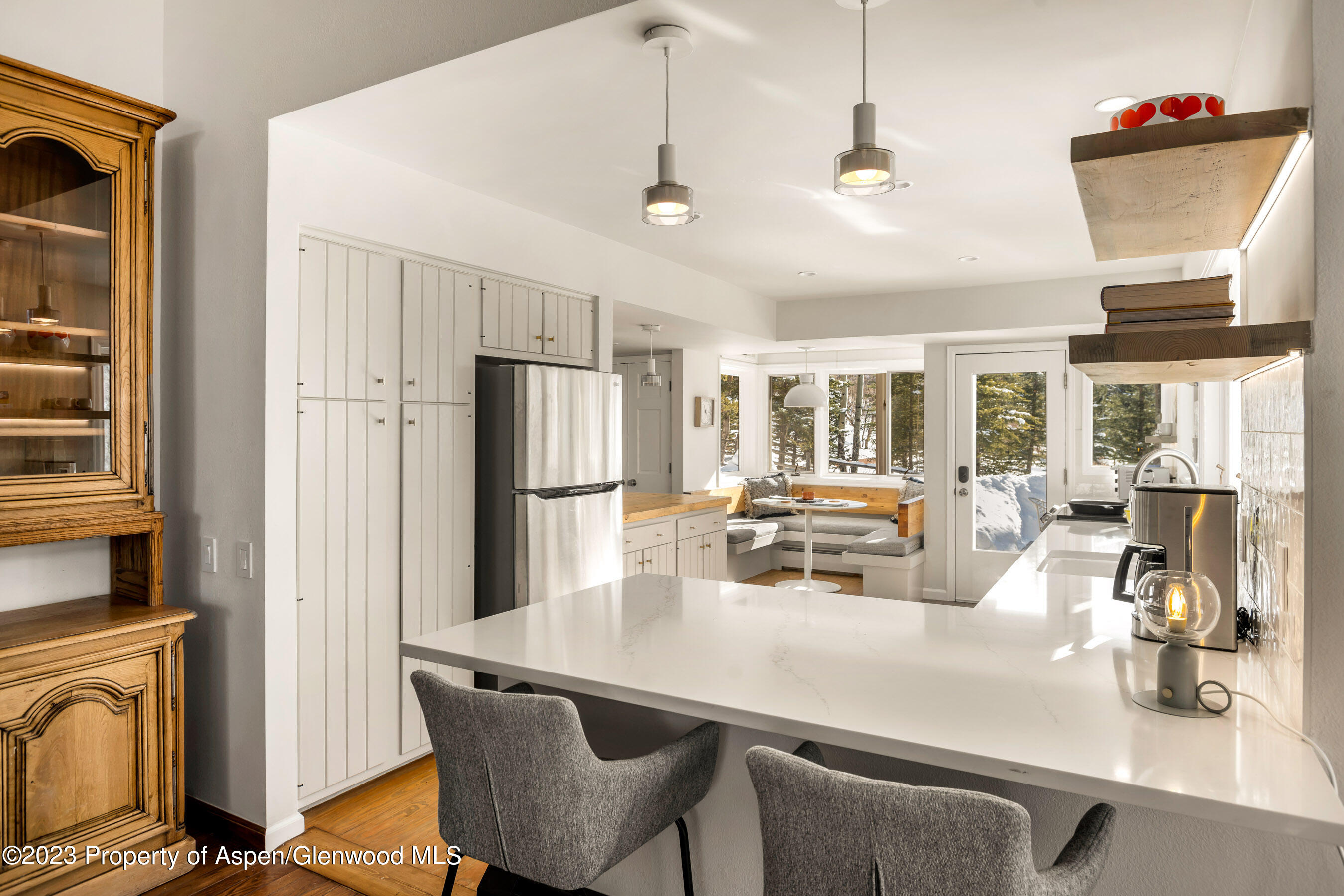 1036 Red Mountain Road Aspen, CO 81611 - Photo 3 of 37 a kitchen with stainless steel appliances granite countertop a dining table and chairs