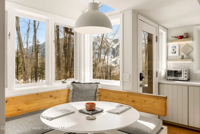 a dining room with furniture and wooden floor