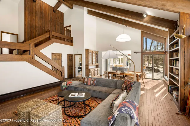 a living room with furniture and a floor to ceiling window