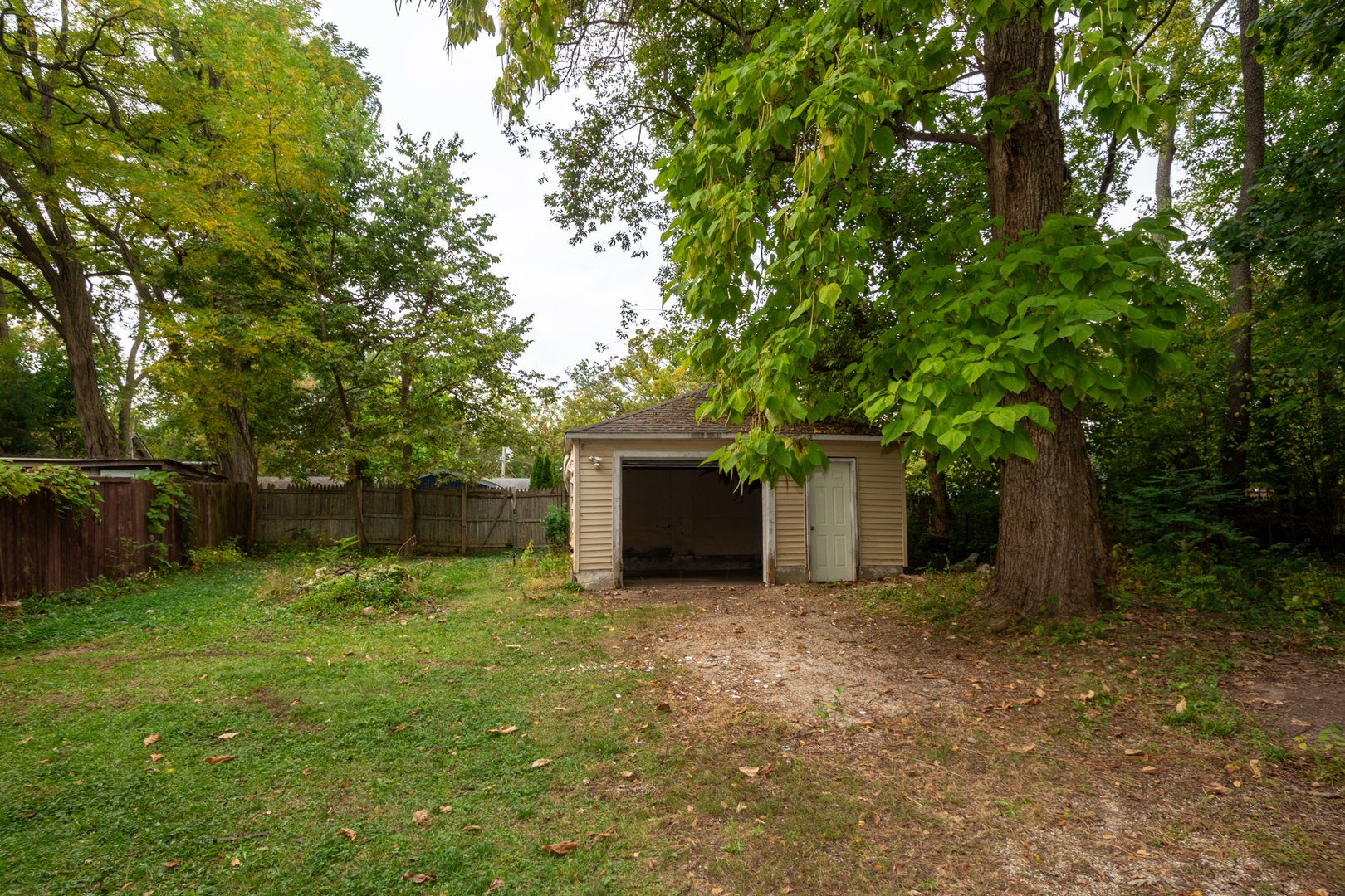 38178 1st Avenue Spring Grove, IL 60081 - Photo 16 of 19 a backyard of a house with lots of plants and tree