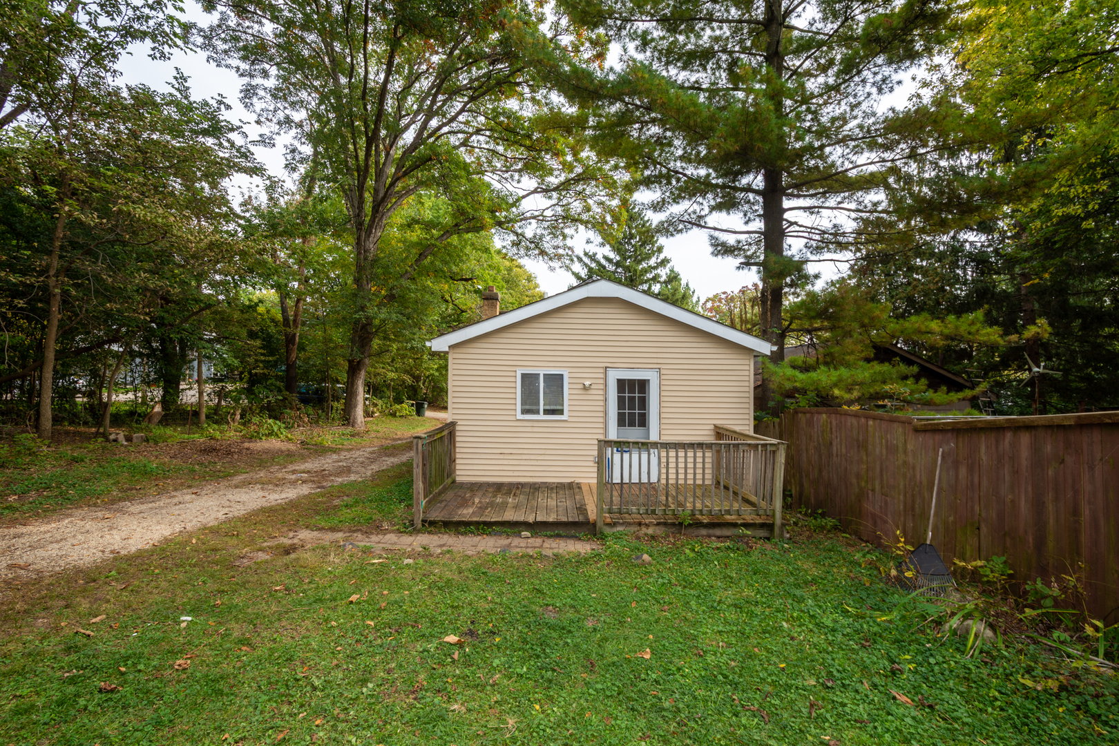 38178 1st Avenue Spring Grove, IL 60081 - Photo 19 of 19 a view of a backyard with large trees and wooden fence