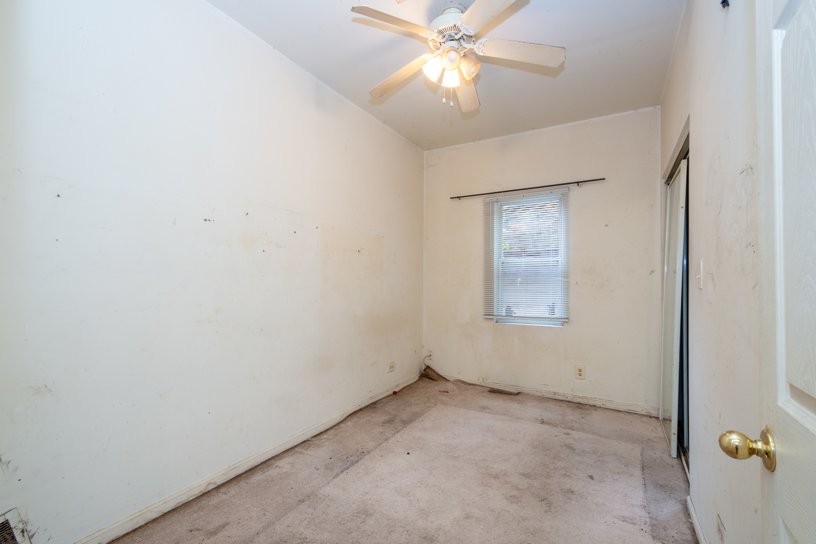 38178 1st Avenue Spring Grove, IL 60081 - Photo 7 of 19 an empty room with a window and a fan