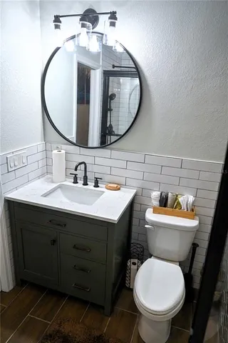 a bathroom with a toilet and a shower curtain
