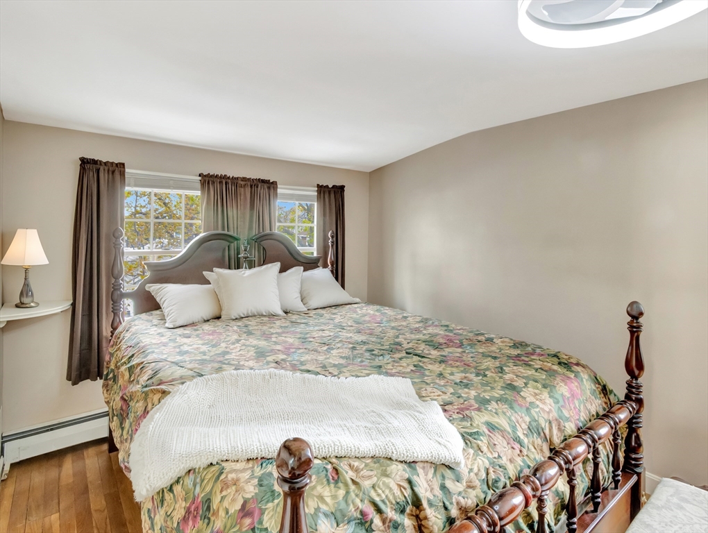 5 G Street Hull, MA 02045 - Photo 29 of 41 a large bed sitting in a bedroom next to a window