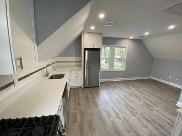 a kitchen with a sink and a refrigerator