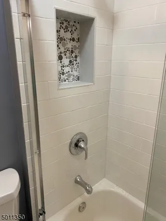 a bathroom with a shower and a toilet