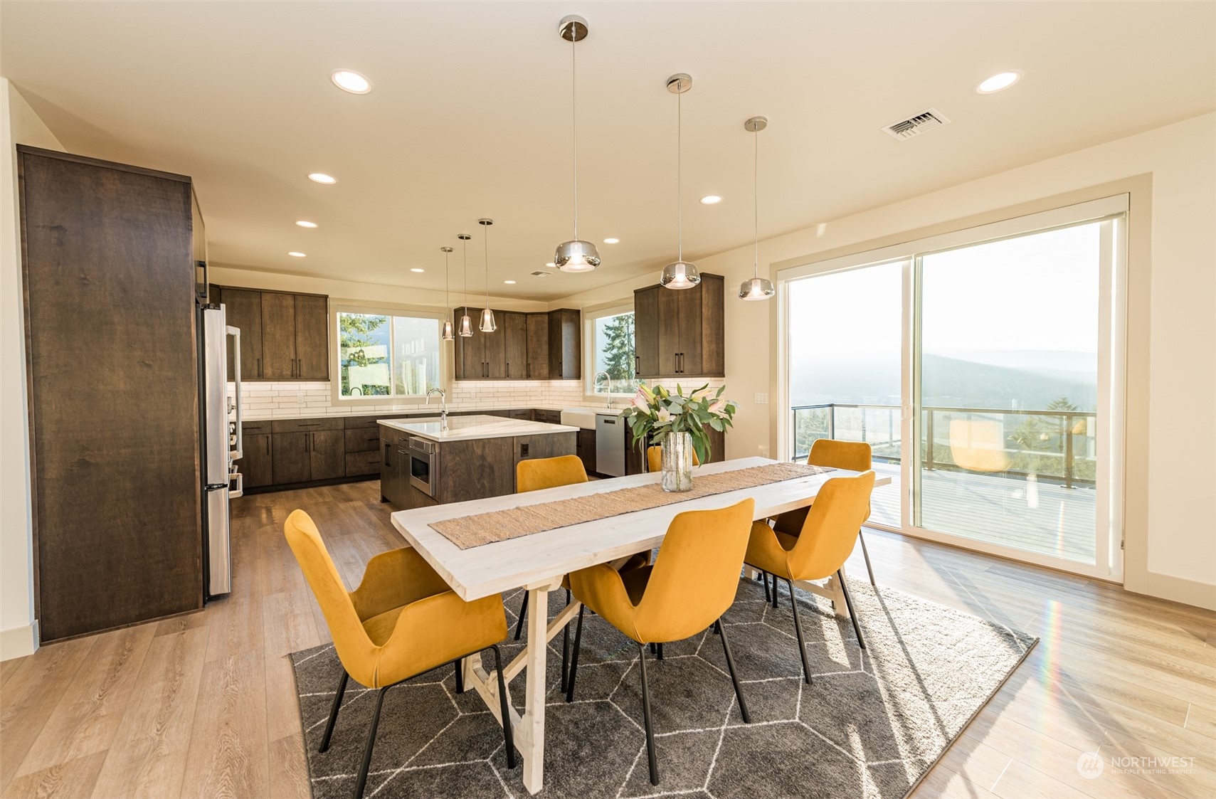 1863 Doe Run Road Sequim, WA 98382 - Photo 13 of 40 a view of a dining room with furniture large windows and wooden floor