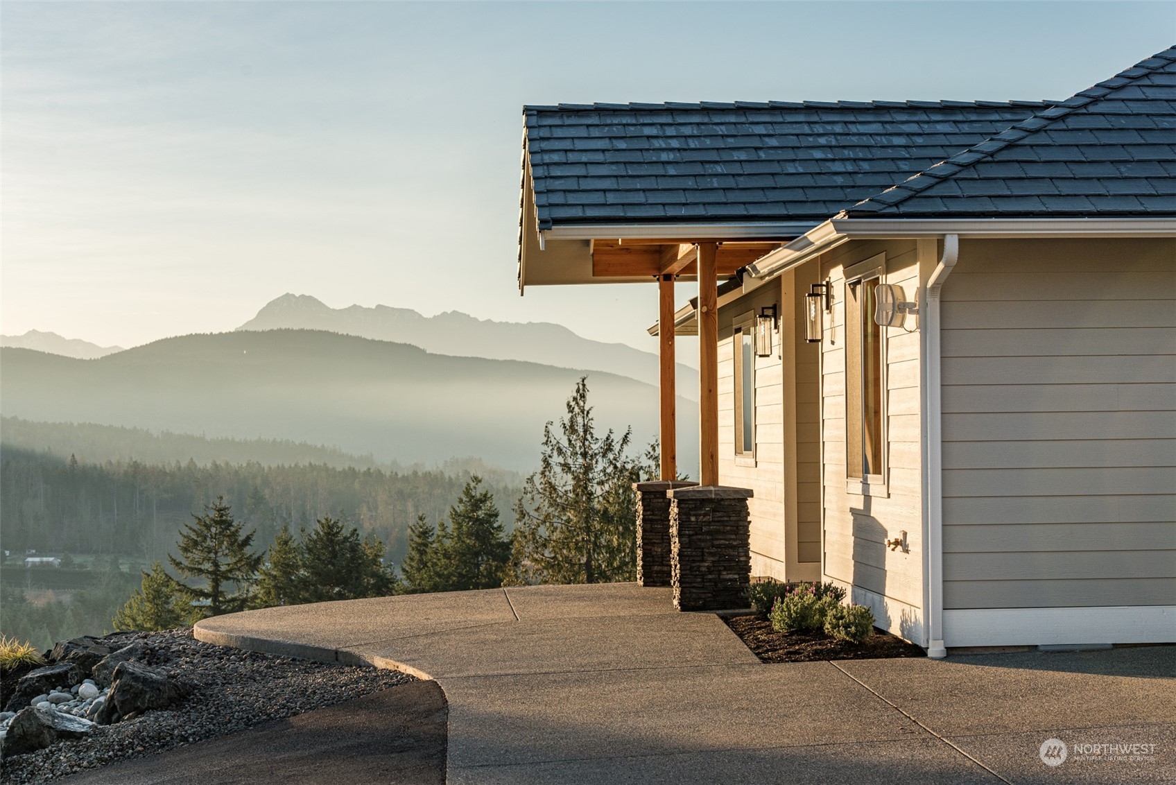 1863 Doe Run Road Sequim, WA 98382 - Photo 4 of 40 a backyard of a house with a fountain and mountain view in back