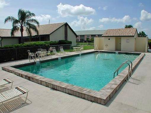 3920 Bal Harbor Boulevard, Unit E4 Punta Gorda, FL 33950 - Photo 1 of 24 a view of a house with a yard and sitting area