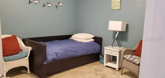 a bedroom with a bed and a lamp