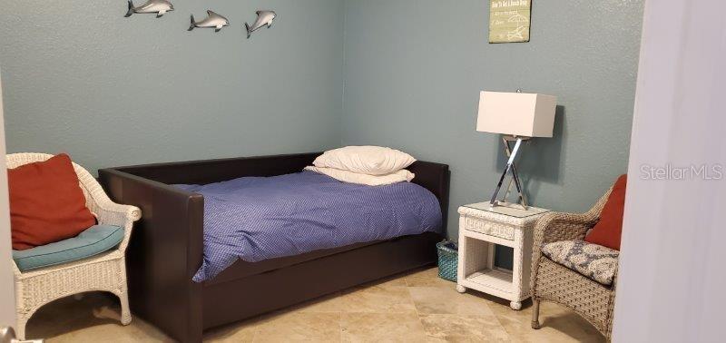 3920 Bal Harbor Boulevard, Unit E4 Punta Gorda, FL 33950 - Photo 16 of 24 a bedroom with a bed and a lamp