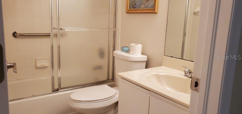 3920 Bal Harbor Boulevard, Unit E4 Punta Gorda, FL 33950 - Photo 18 of 24 a bathroom with a sink a toilet and shower