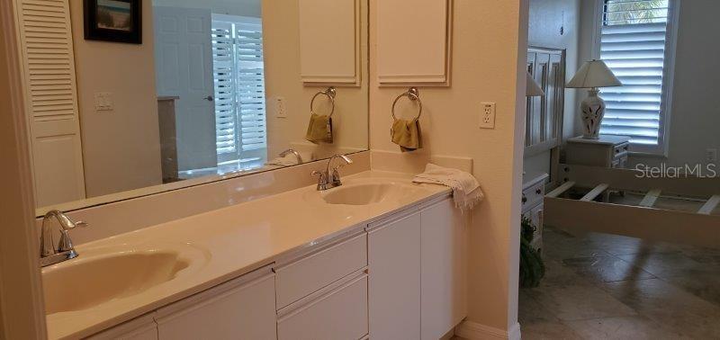3920 Bal Harbor Boulevard, Unit E4 Punta Gorda, FL 33950 - Photo 20 of 24 a bathroom with a sink and a mirror