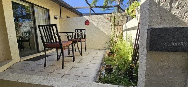 a view of a porch with furniture and a yard