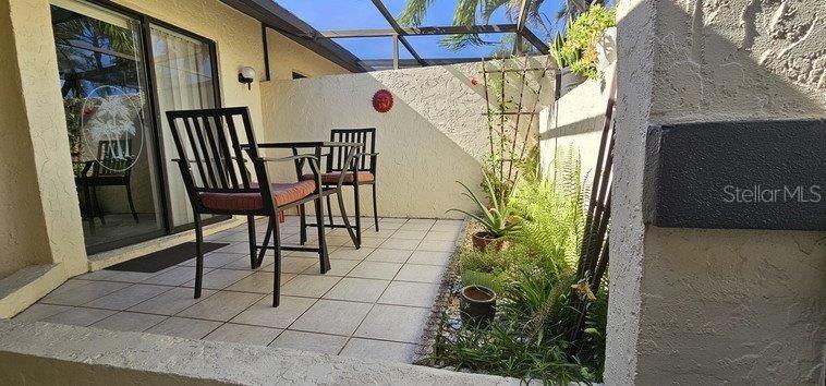 3920 Bal Harbor Boulevard, Unit E4 Punta Gorda, FL 33950 - Photo 4 of 24 a view of a porch with furniture and a yard