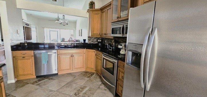 3920 Bal Harbor Boulevard, Unit E4 Punta Gorda, FL 33950 - Photo 7 of 24 a kitchen with white cabinets and white appliances