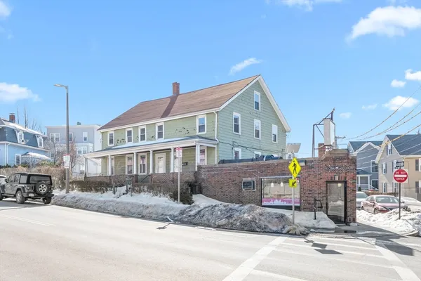 a front view of a building with parking space