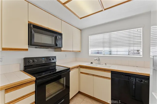 a kitchen with stainless steel appliances a stove sink microwave and cabinets