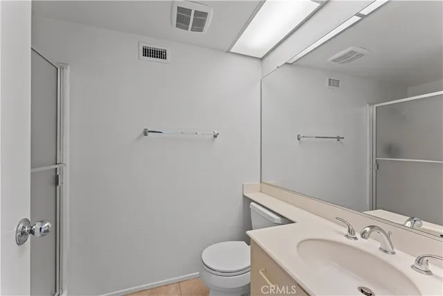 a white toilet sitting next to a shower