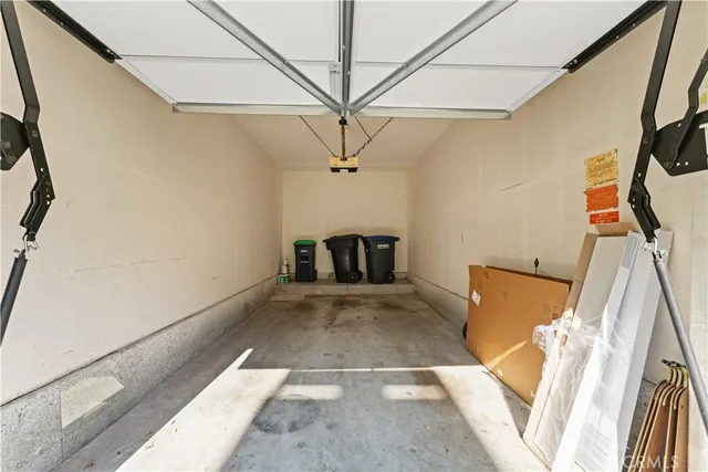 a view of a white house with wooden floor and fence