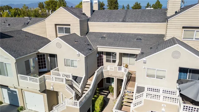 an aerial view of multiple houses with yard