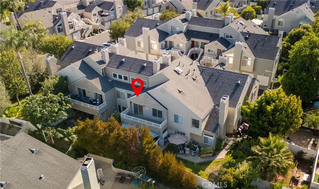 an aerial view of a residential houses with outdoor space