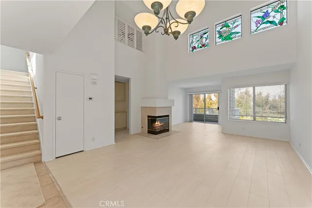 a view of a livingroom with an empty space and a fireplace