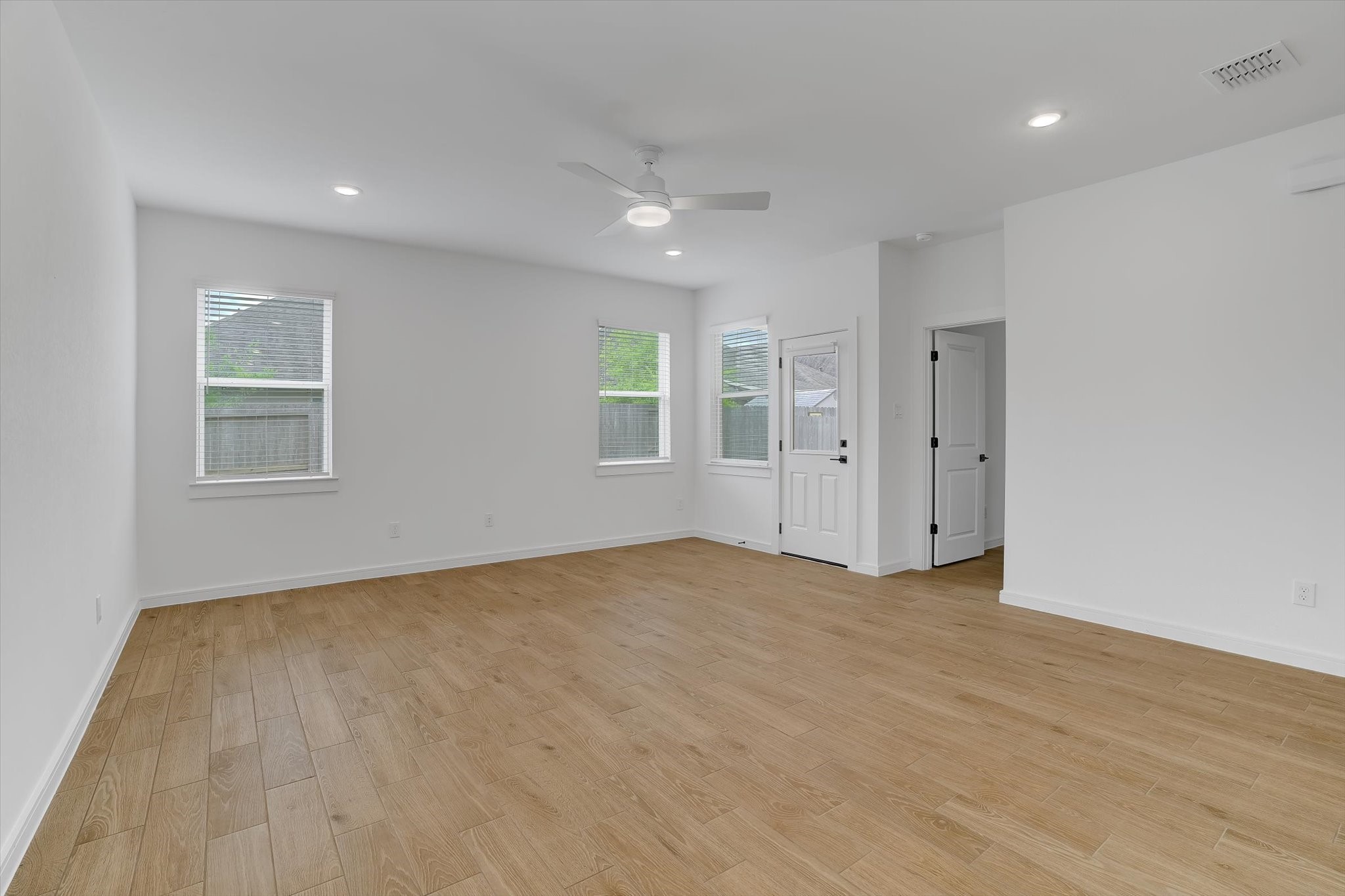 8438 Bay Rdg Circle Baytown, TX 77523 - Photo 23 of 44 a view of an empty room with a window and wooden floor