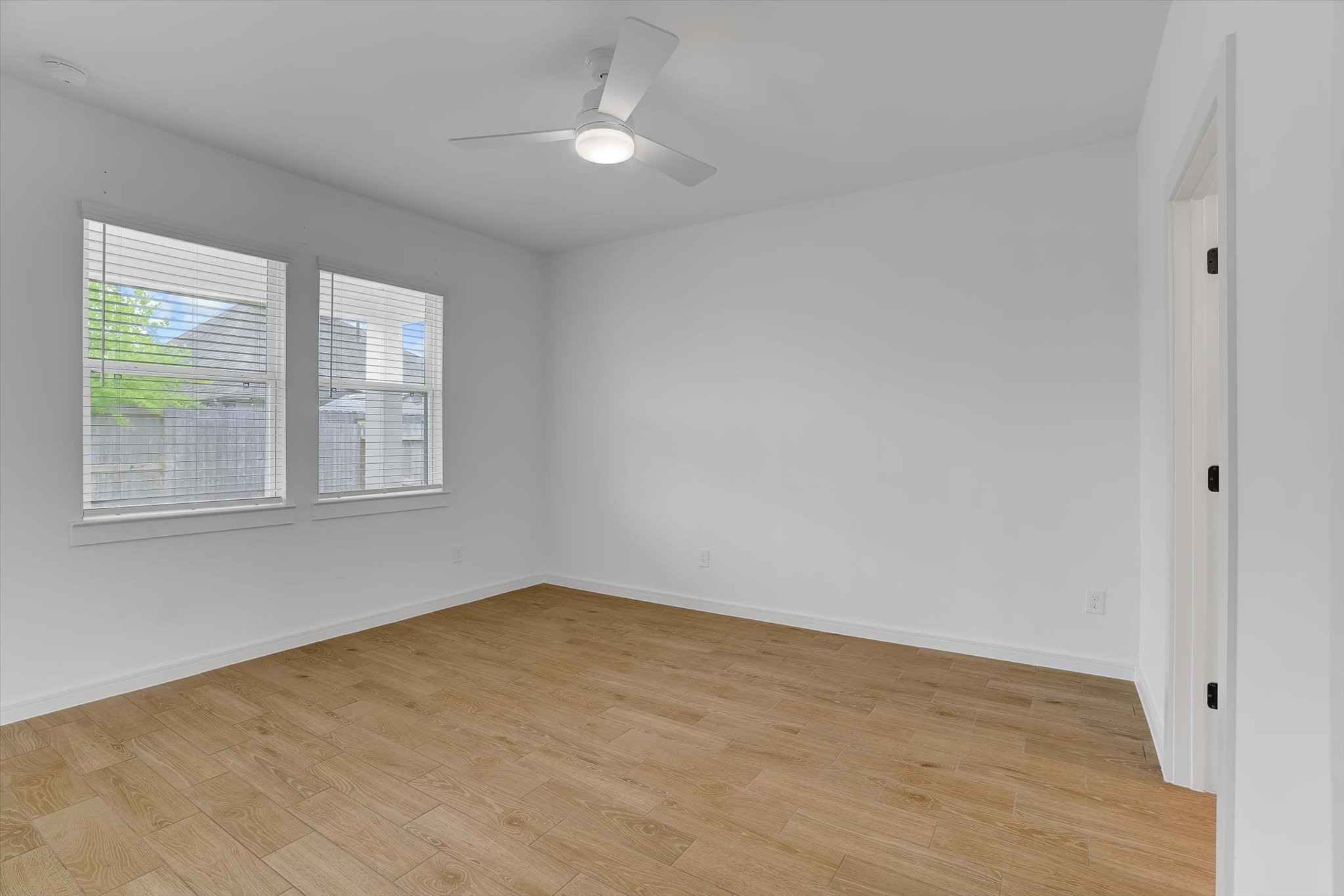 8438 Bay Rdg Circle Baytown, TX 77523 - Photo 25 of 44 wooden floor in an empty room with a window