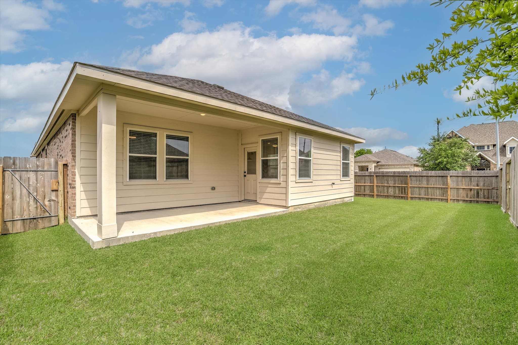 8438 Bay Rdg Circle Baytown, TX 77523 - Photo 41 of 44 a view of a backyard with potted plants and wooden fence