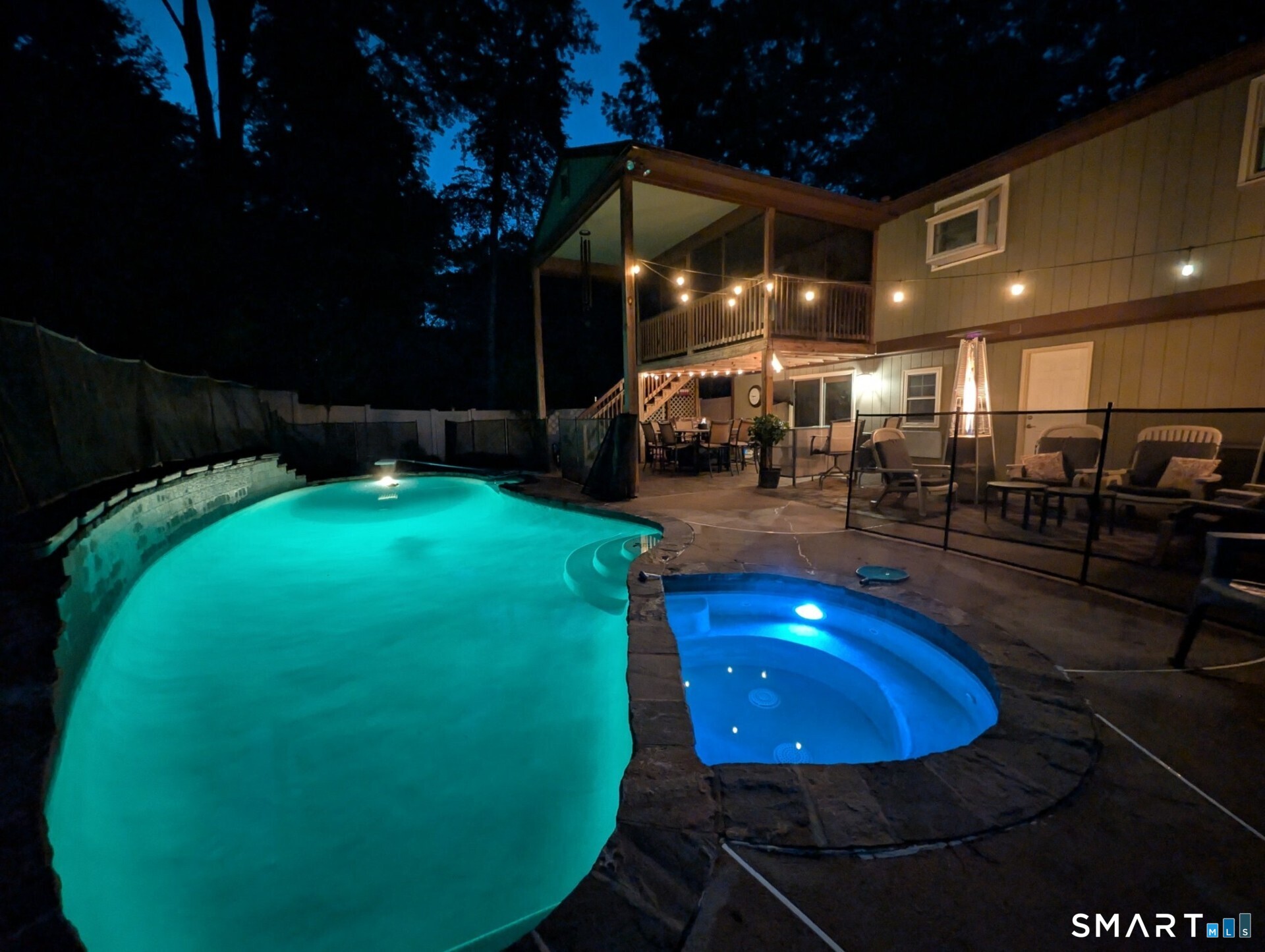 122 Ridgeview Circle Guilford, CT 06437 - Photo 33 of 40 Owner photo shows the lighted pool and spa at night, highlighting a serene and inviting setting.