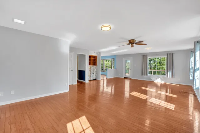 a view of staircase with railing and a chandelier