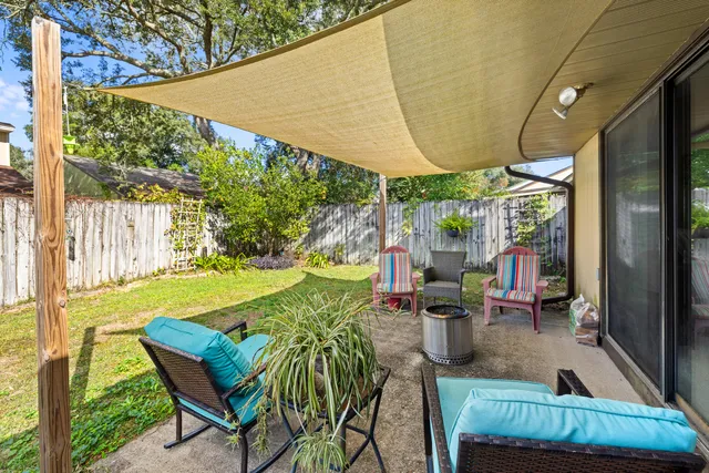 a view of an outdoor dining space with a table and chairs
