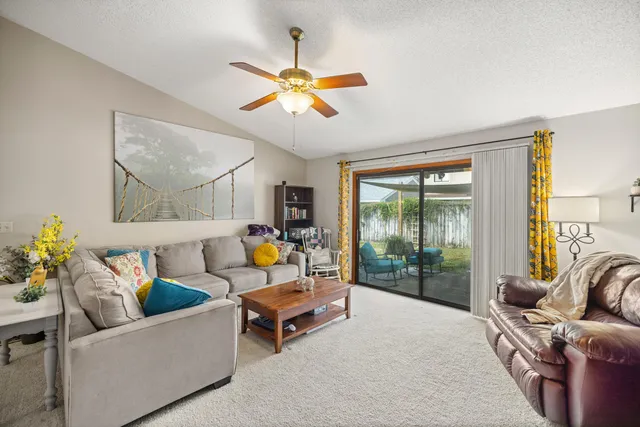 a living room with furniture and a floor to ceiling window