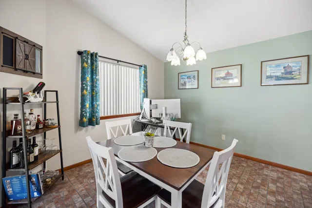 a view of a dining room with furniture and chandelier