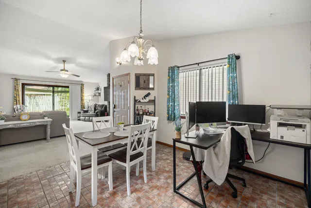 a view of a dining room with furniture a rug and wooden floor