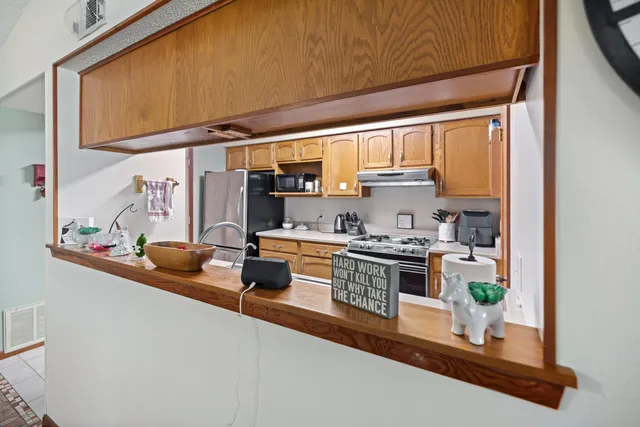 a kitchen with a sink appliances and cabinets