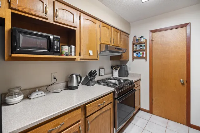 a kitchen with stainless steel appliances a sink stove and cabinets