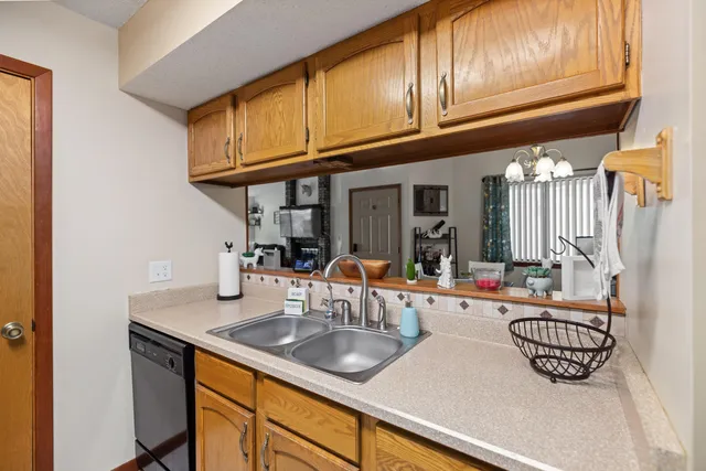 a kitchen with granite countertop a sink a stove and cabinets