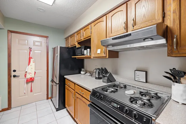 a kitchen with stainless steel appliances granite countertop a stove a refrigerator and a refrigerator