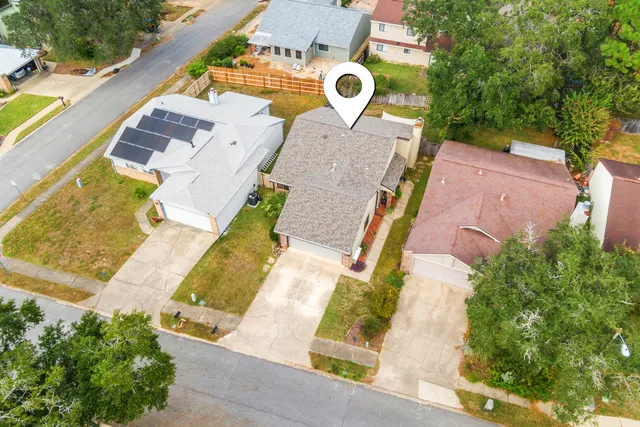 an aerial view of residential house with yard and swimming pool