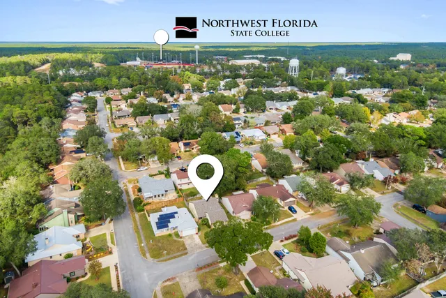 an aerial view of residential houses with outdoor space and street view