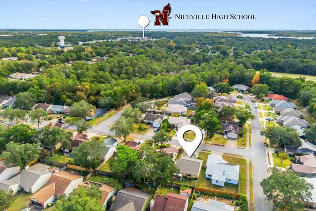 an aerial view of residential houses with outdoor space and street view