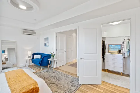 a bedroom with a bed and wooden floor