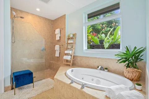 a bathroom with a tub sink and mirror