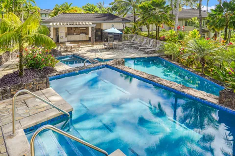 a swimming pool with outdoor seating and yard