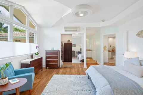 a bedroom with furniture and wooden floor