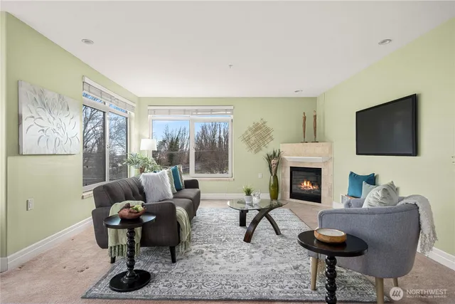 a living room with furniture a fireplace and a table