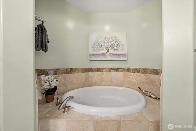 a bathroom with a granite countertop sink mirror and a toilet